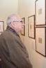 Thomas Geve (Stefan Cohn) looking at his drawings on display in Yad Vashem's Museum of Holocaust Art